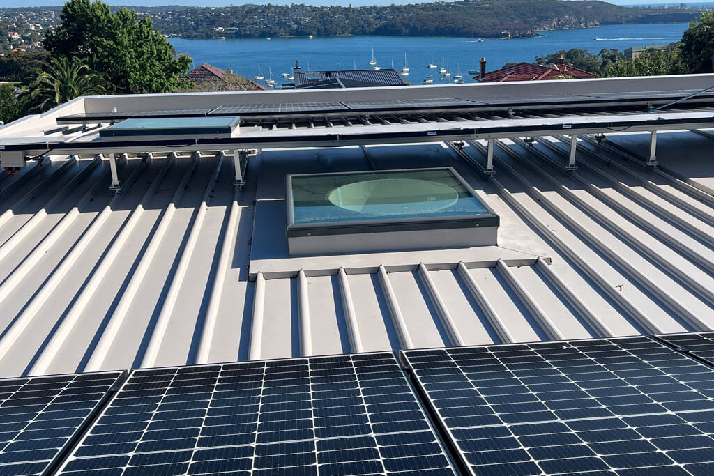 Flat metal roof that has a polycrystalline solar panels and a circle like skylight roof